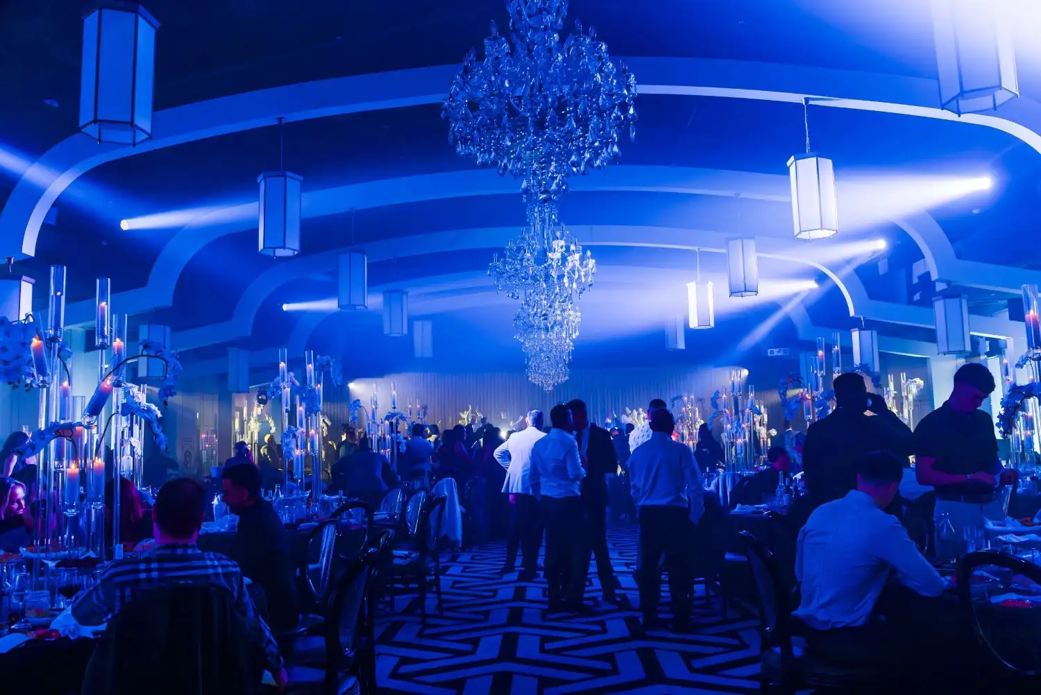 Professional event setup featuring sophisticated mood lighting and AV integration for corporate functions