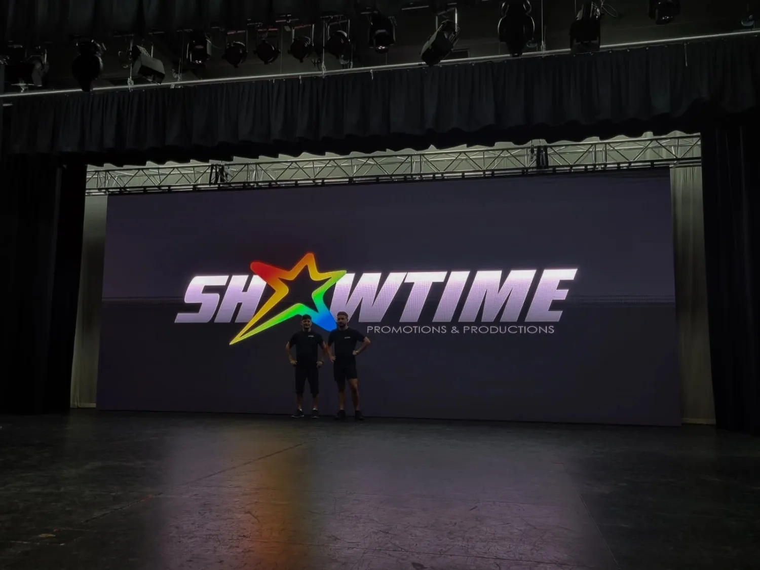 Professional stage setup featuring large LED screen displays for conferences and presentations