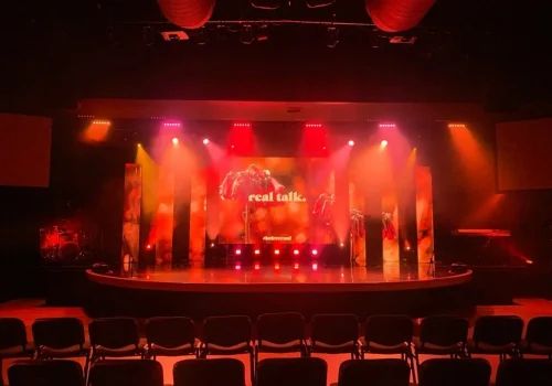 Professional theatre stage with red lighting and LED backdrop display Professional theatre stage with red lighting and LED backdrop display
